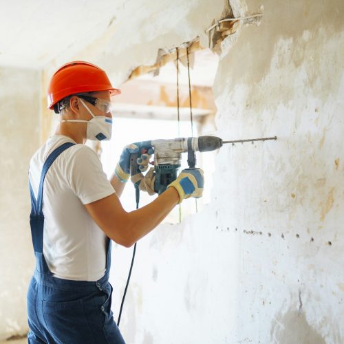 repairer-in-boilersuit-holding-tools-apartment-repair-and-renovation-concept-building-.jpg